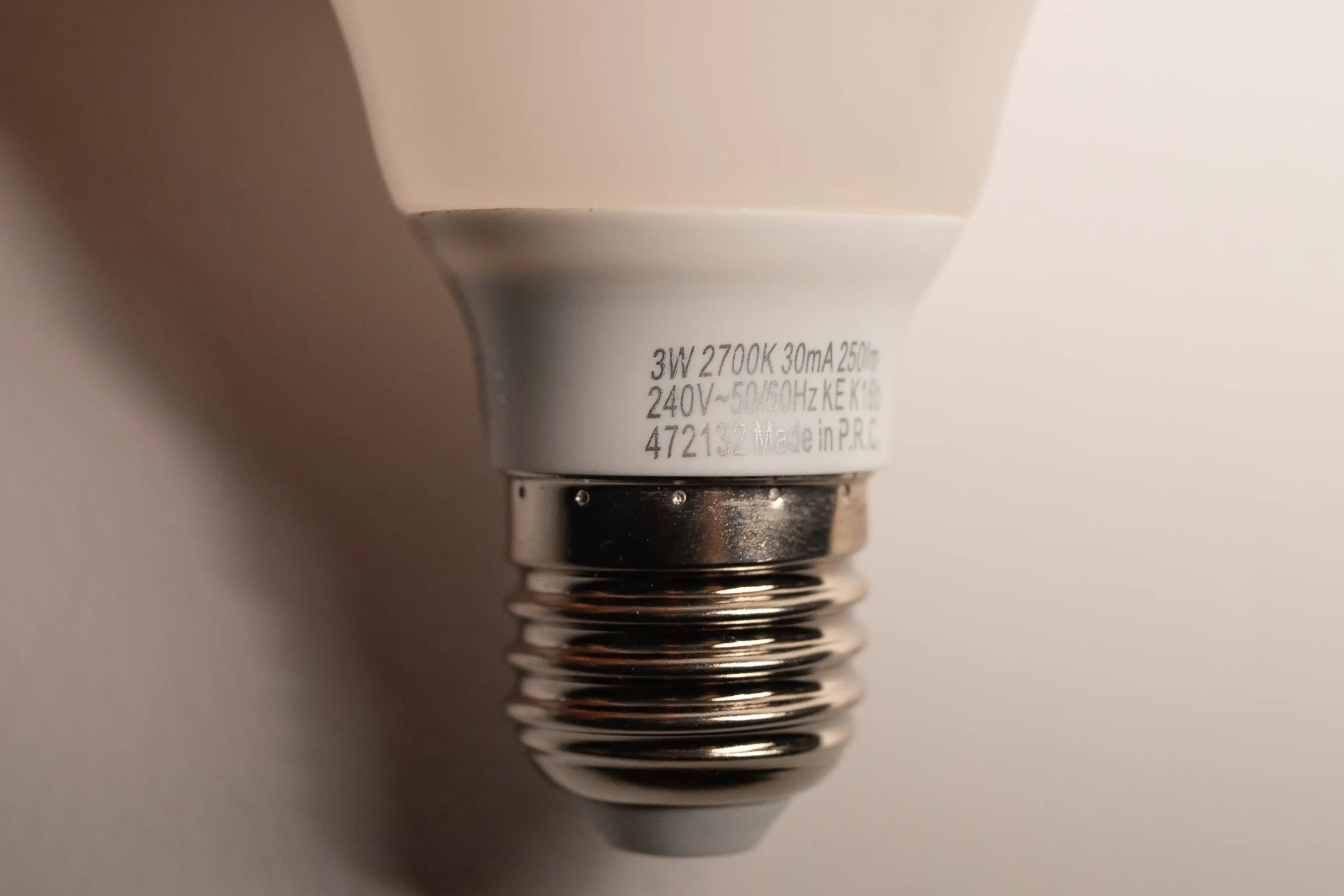 Close-up shot of a lightbulb with label stating the power consumption of 3W.