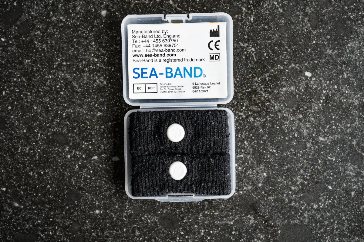 Sea sickness band case on a black background, opened